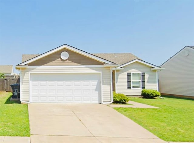 ranch-style house with a garage and a front lawn