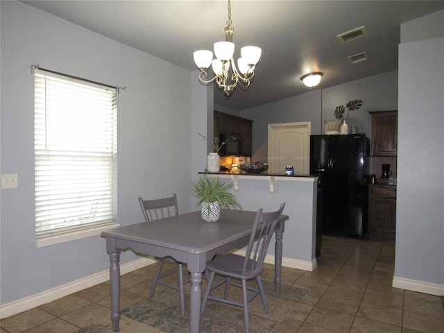 1617 NW 144th Ter, Edmond, OK 73013 - dining area featuring a chandelier and tile patterned flooring