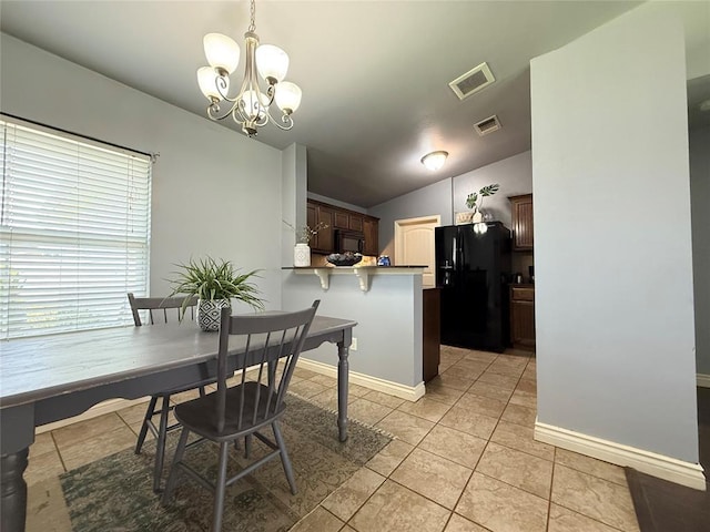 1617 NW 144th Ter, Edmond, OK 73013 - dining space featuring a chandelier, light tile patterned floors, and lofted ceiling