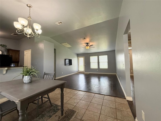 1617 NW 144th Ter, Edmond, OK 73013 - dining space with light tile patterned floors, a chandelier, lofted ceiling, and a ceiling fan