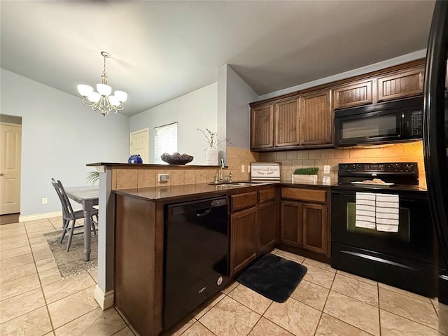 1617 NW 144th Ter, Edmond, OK 73013 - kitchen featuring black appliances, lofted ceiling, dark countertops, a chandelier, and decorative backsplash