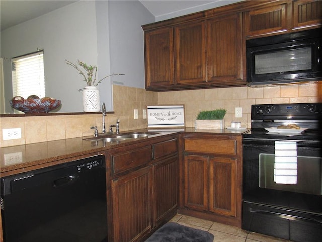 1617 NW 144th Ter, Edmond, OK 73013 - kitchen with black appliances, light tile patterned floors, dark stone counters, and tasteful backsplash