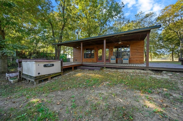 exterior space featuring ceiling fan, a hot tub, and a deck