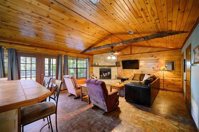 living room featuring ceiling fan, french doors, wooden ceiling, vaulted ceiling with beams, and wood walls