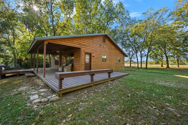 view of home's exterior with a yard and a wooden deck