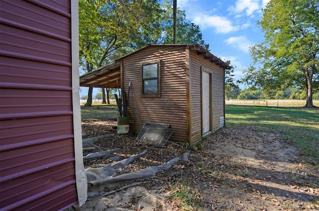 view of outbuilding featuring a lawn