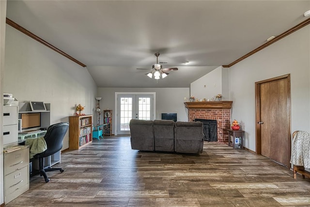 living room featuring french doors, dark hardwood / wood-style flooring, a brick fireplace, vaulted ceiling, and crown molding