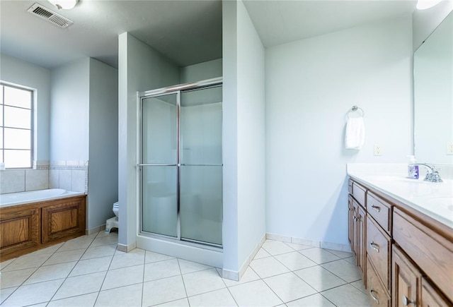 full bathroom with tile patterned flooring, vanity, toilet, and independent shower and bath