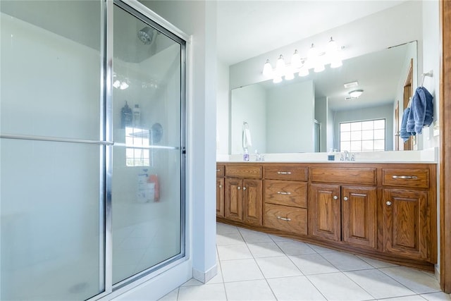 bathroom with tile patterned flooring, vanity, and a shower with shower door