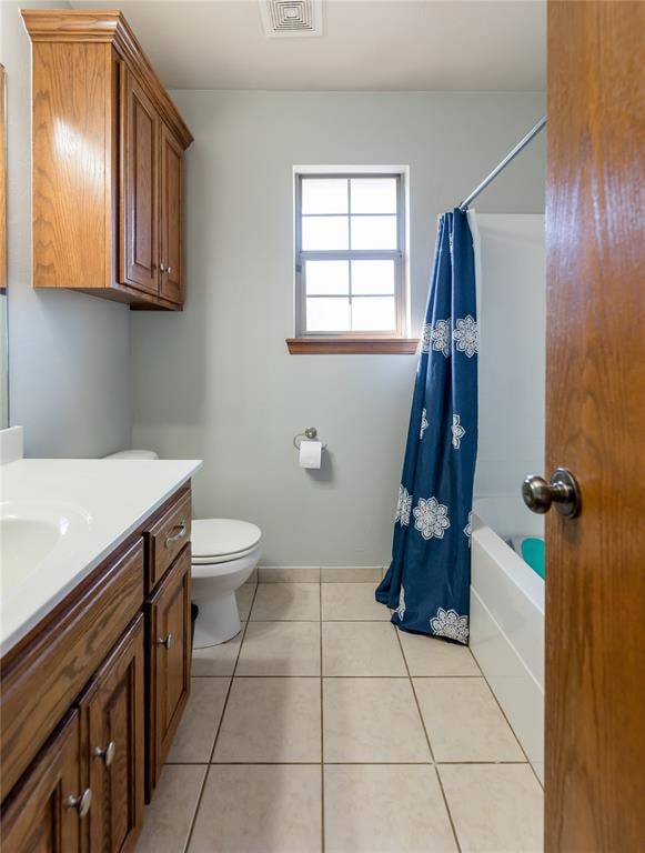 full bathroom featuring tile patterned flooring, vanity, toilet, and shower / tub combo