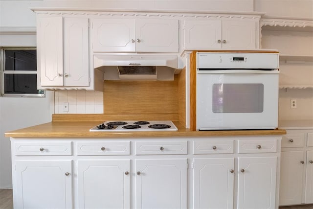 kitchen featuring white cabinetry, white appliances, and tasteful backsplash