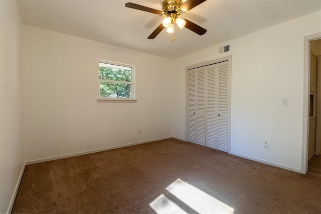 unfurnished bedroom featuring carpet floors, a closet, and ceiling fan