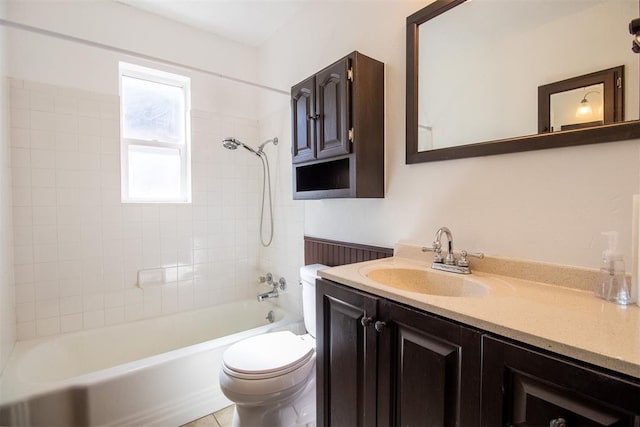 full bathroom with vanity, tiled shower / bath combo, and toilet