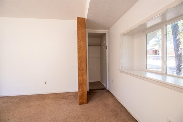 unfurnished bedroom with carpet flooring, a closet, and a textured ceiling