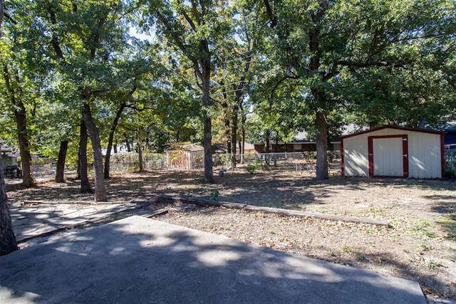 view of yard featuring a patio and a storage shed