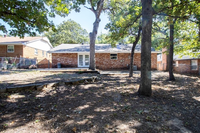 rear view of house featuring french doors