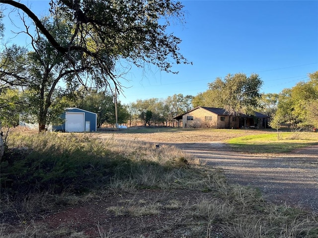 view of yard with an outbuilding and a garage