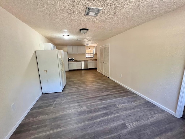 kitchen with white cabinetry, stainless steel dishwasher, white fridge with ice dispenser, and dark wood-type flooring