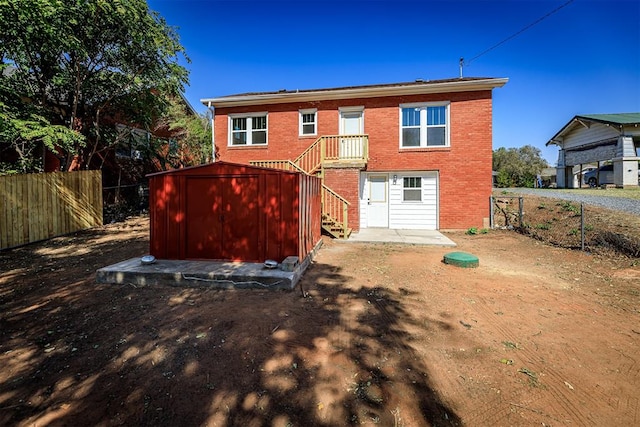 back of property with a shed