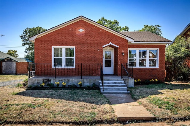 bungalow-style home featuring a shed