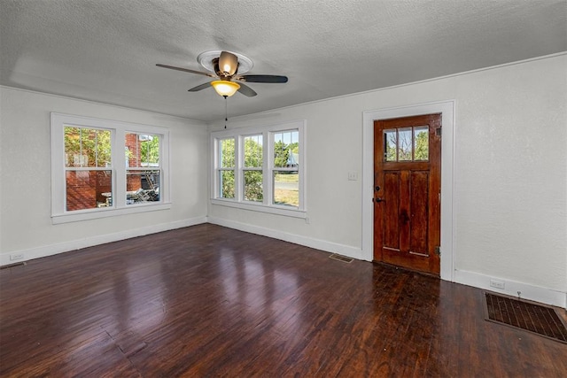 foyer featuring dark hardwood / wood-style floors, ceiling fan, plenty of natural light, and a textured ceiling