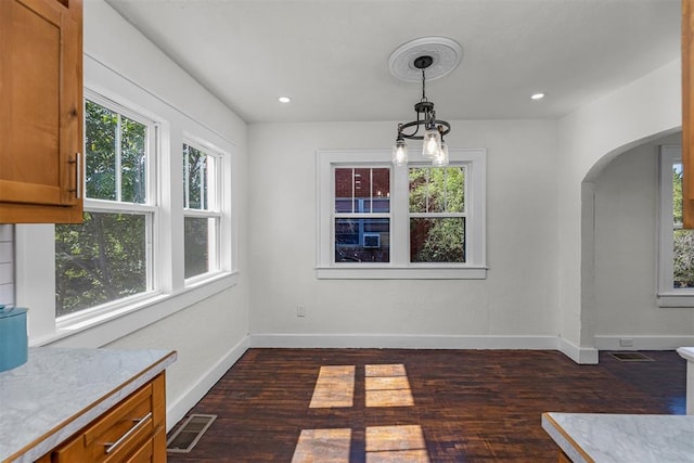 unfurnished dining area with dark hardwood / wood-style floors