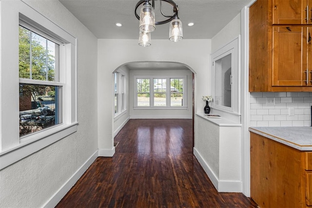 interior space with dark hardwood / wood-style floors and an inviting chandelier