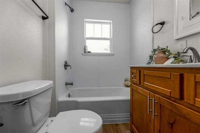 full bathroom featuring hardwood / wood-style flooring, vanity, tub / shower combination, and toilet