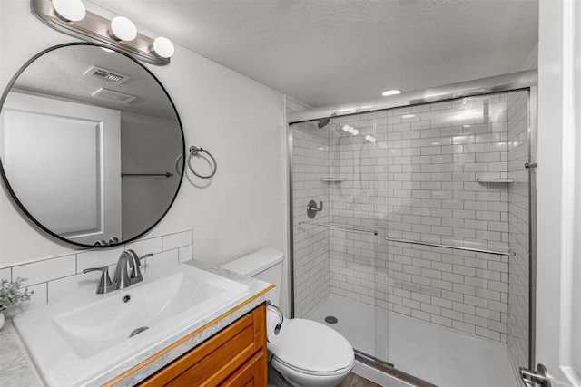 bathroom featuring decorative backsplash, walk in shower, vanity, a textured ceiling, and toilet