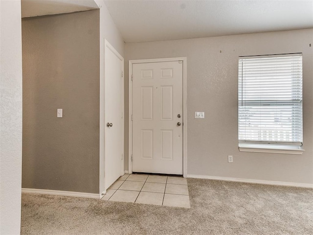 carpeted foyer entrance featuring plenty of natural light