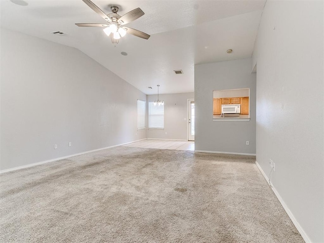 carpeted empty room with ceiling fan and lofted ceiling