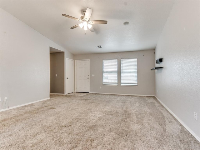 carpeted spare room featuring ceiling fan