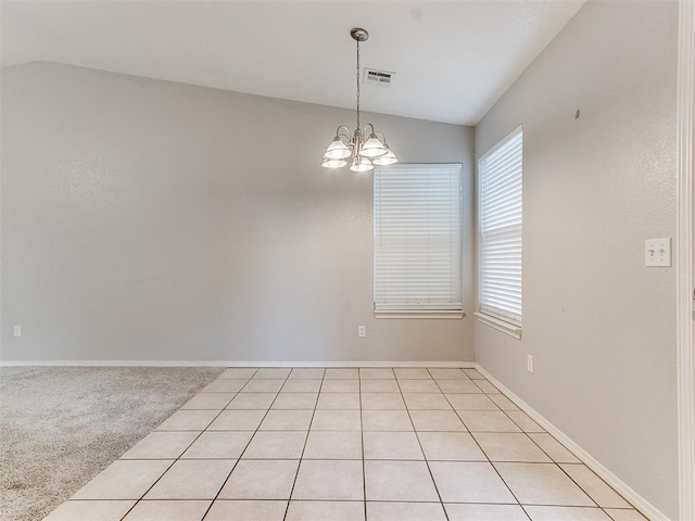 unfurnished room with light carpet, a chandelier, and lofted ceiling