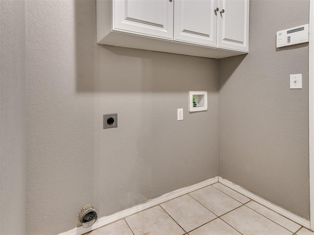 washroom featuring hookup for a washing machine, light tile patterned floors, cabinets, and hookup for an electric dryer