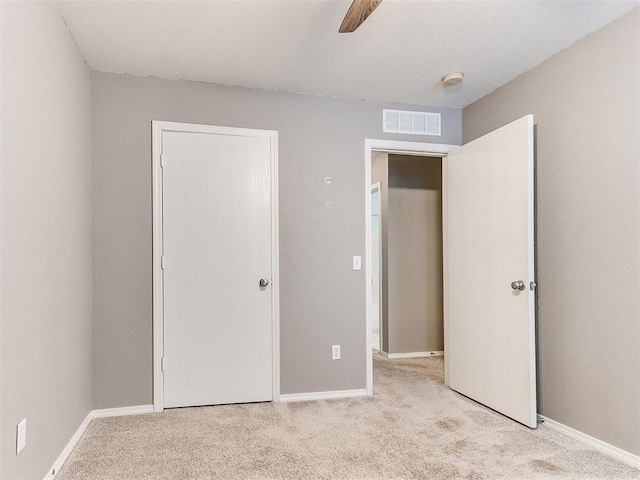 unfurnished bedroom featuring ceiling fan and light colored carpet