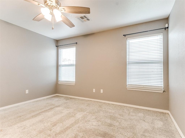 empty room with ceiling fan and carpet floors