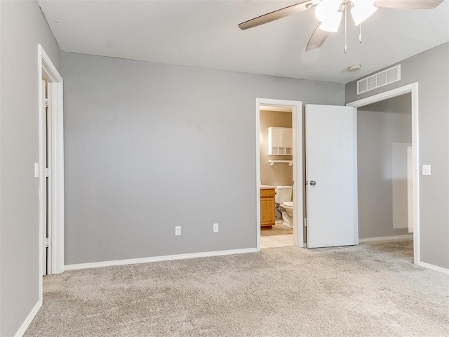 unfurnished bedroom featuring connected bathroom, ceiling fan, and light carpet