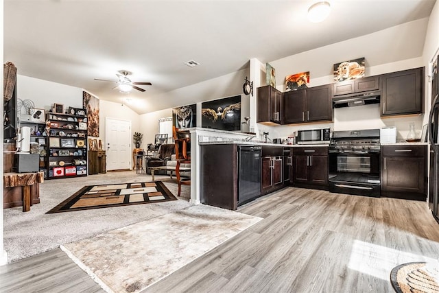 kitchen with black appliances, light wood-type flooring, kitchen peninsula, and vaulted ceiling