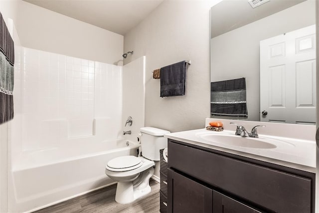 full bathroom with vanity, wood-type flooring, bathtub / shower combination, and toilet