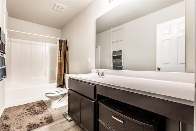 full bathroom with vanity, toilet, shower / bathtub combination with curtain, and hardwood / wood-style flooring