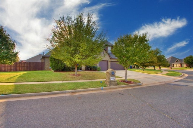 obstructed view of property with a garage and a front yard