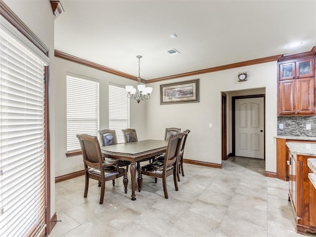 dining area with light tile patterned floors, an inviting chandelier, and crown molding