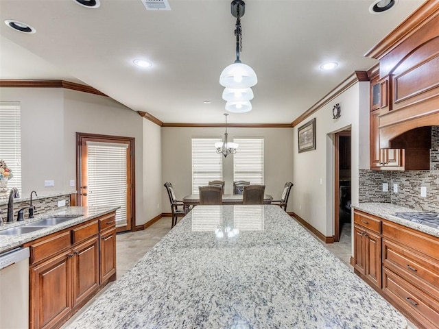 kitchen with dishwasher, sink, light stone counters, a chandelier, and decorative light fixtures