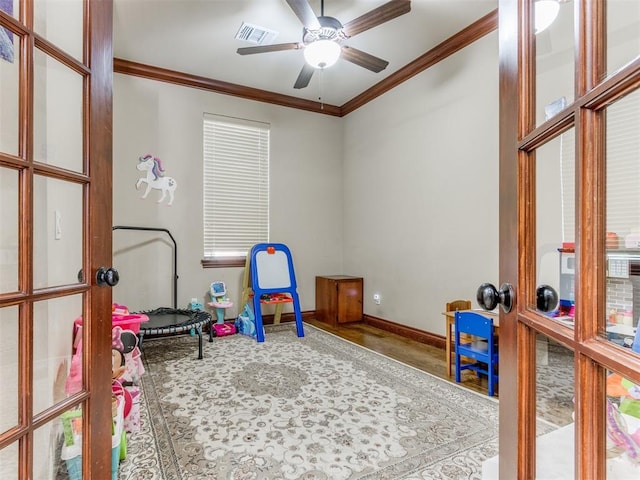 playroom featuring crown molding and ceiling fan