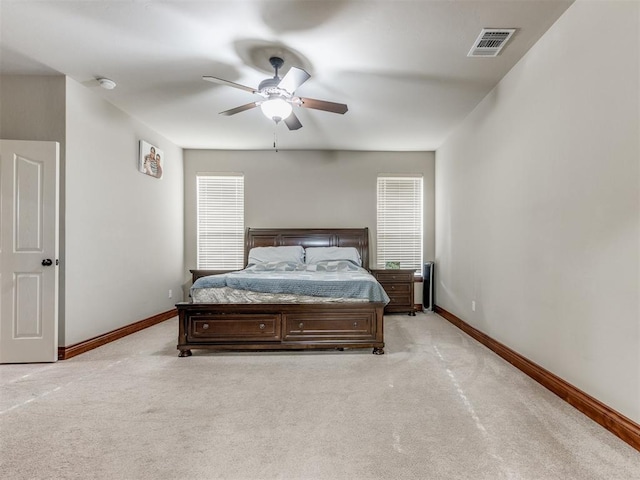 bedroom with ceiling fan and light colored carpet