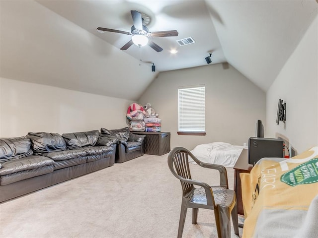 carpeted living room with ceiling fan and vaulted ceiling