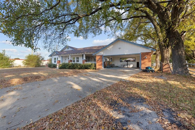 ranch-style house with a porch and a carport