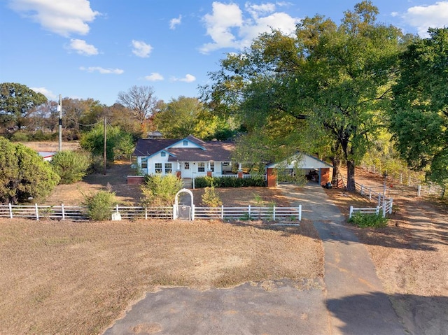 view of front facade featuring a fenced front yard and a rural view