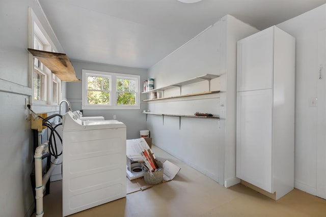 laundry area featuring washer / clothes dryer and cabinet space