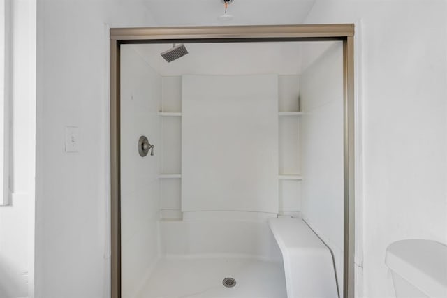 bathroom with toilet and walk in shower